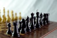 Black Chess Piece on Chess Board