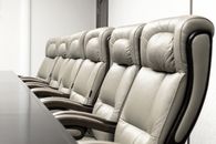 Gray Leather Padded Armchair Beside White Wall