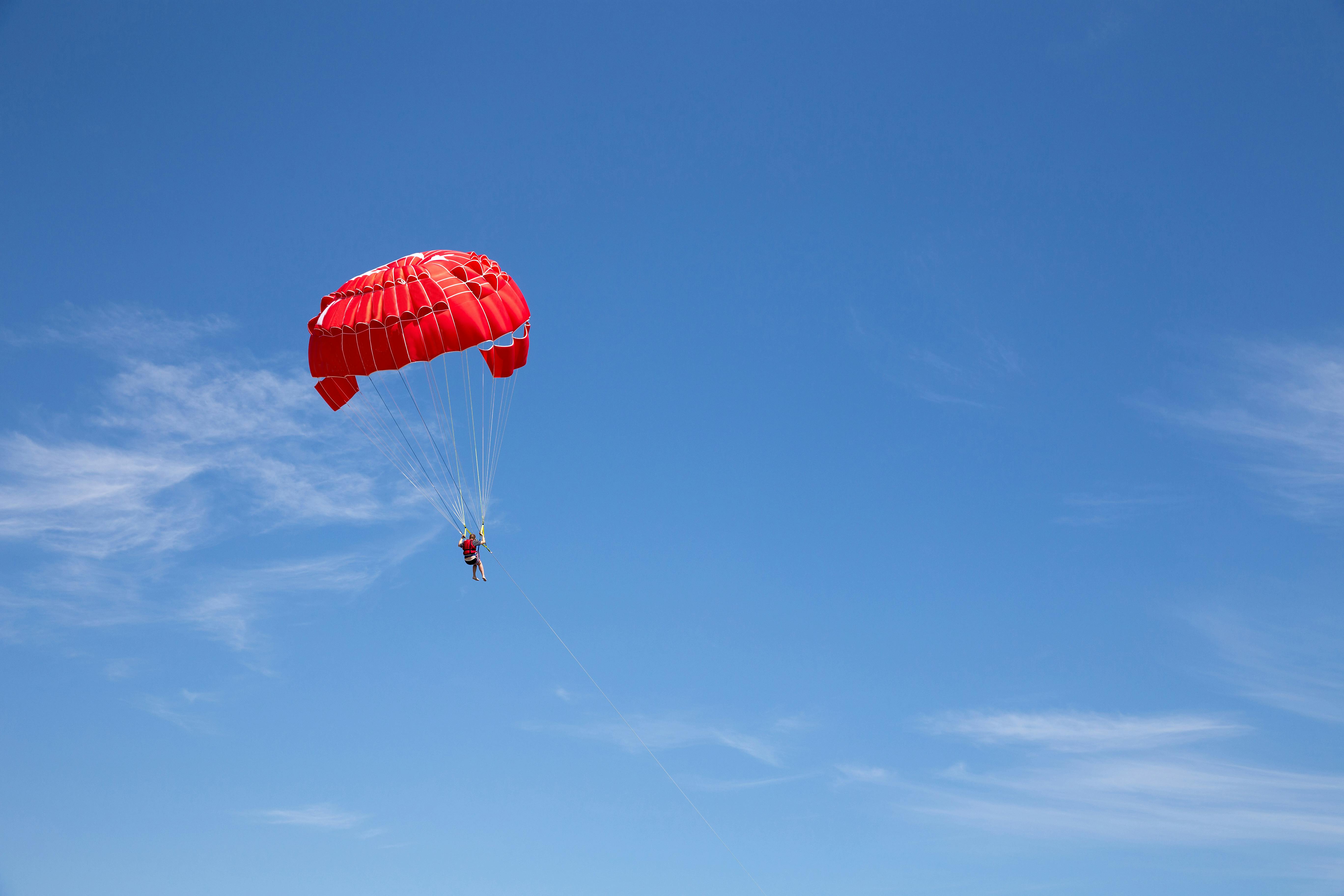 a person parasailing in the sky