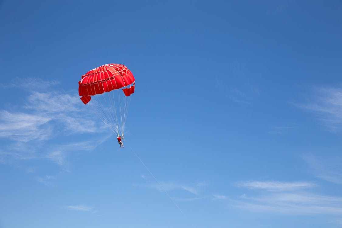 a person parasailing in the sky