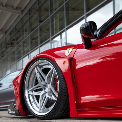 Free Close-up of a sleek, red sports car with luxurious rims, showcasing design elegance. Stock Photo