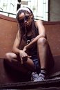 Woman in Sunglasses Squatting on Metal Stairs