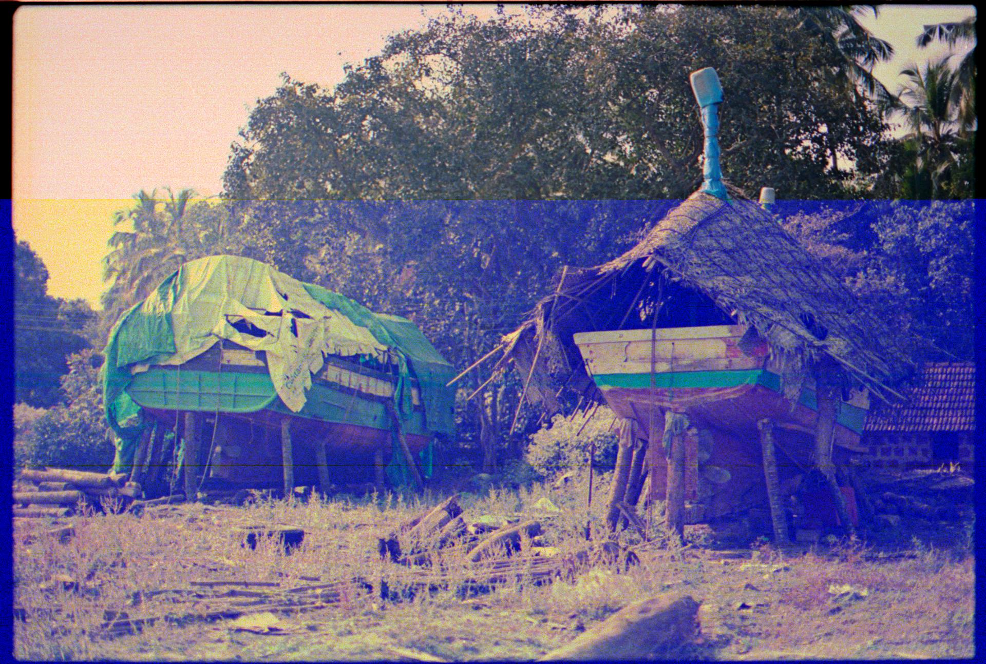 Boats Stored on Shore and Covered with Rags and Mats