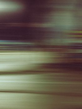 Dynamic urban night scene captured in abstract blurred motion showcasing city lights.