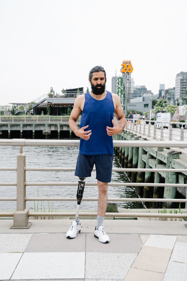 Man With Prosthetic Leg Standing Near River