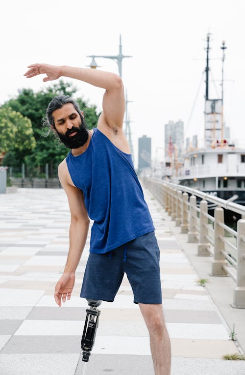 Man with prosthetic Legs doing Stretching Exercises