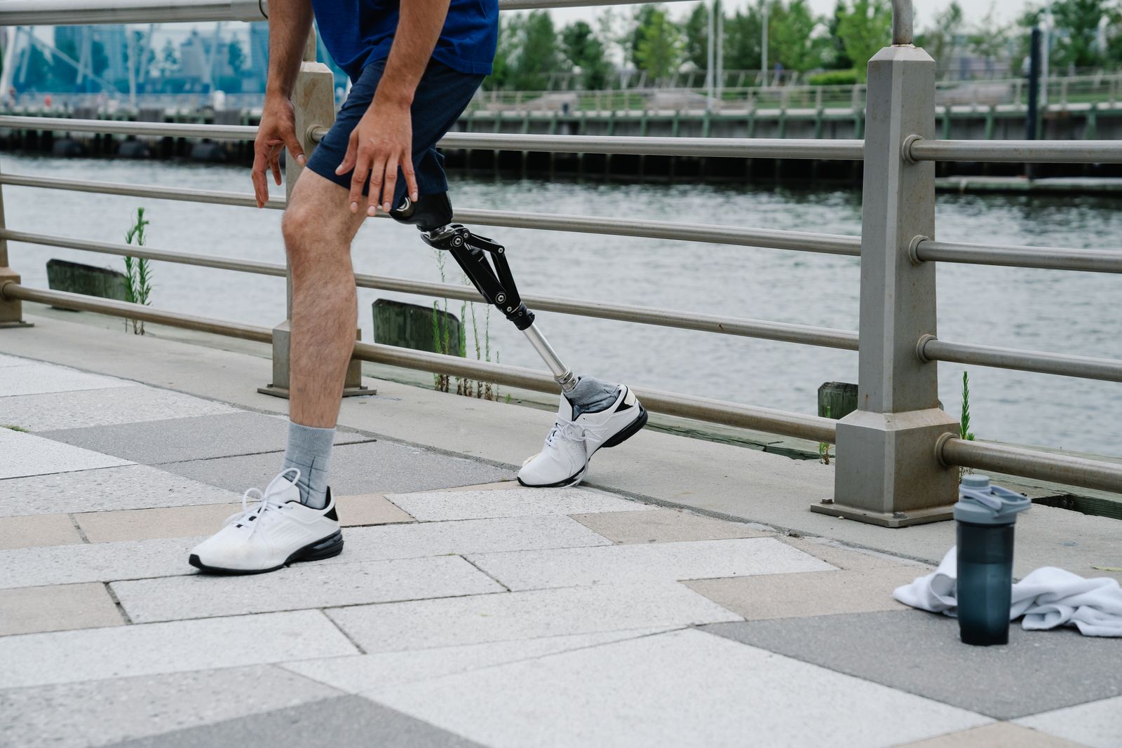Person walking outdoors on a bright path, showing ankle and foot movement