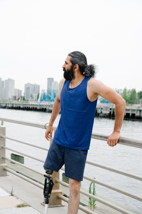 Man with Prosthetic Leg wearing Blue Sleeveless Shirt 