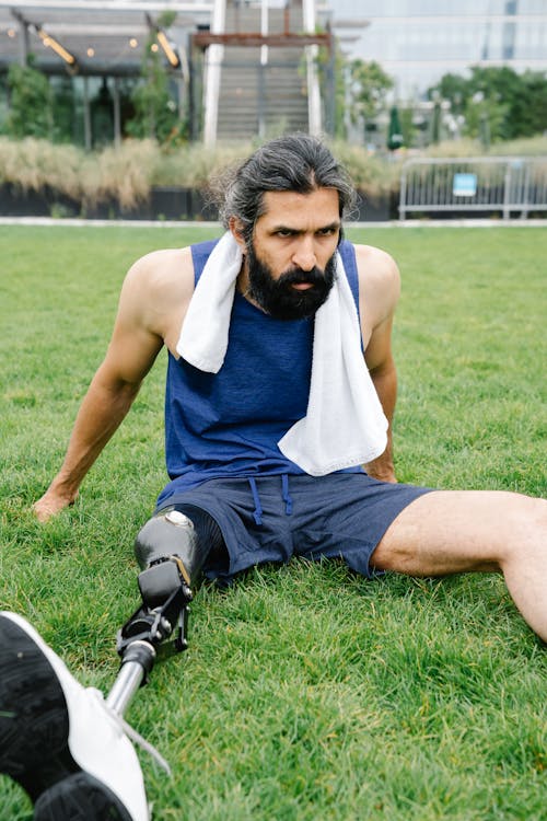 Man with Prosthetic Leg resting on Grass