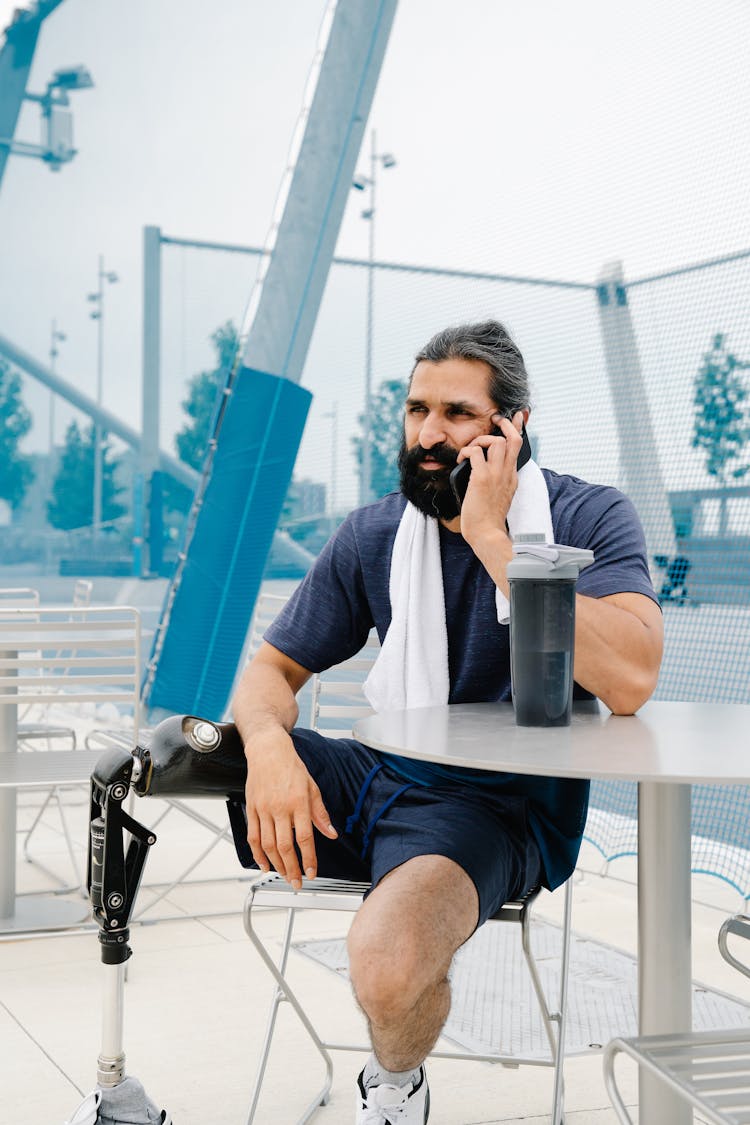 Male Amputee Talking On A Phone