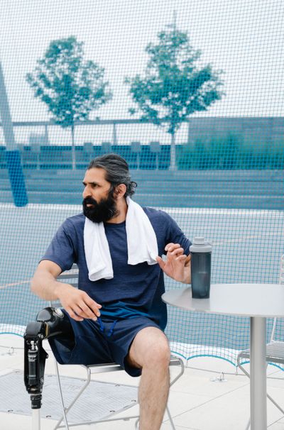 Man with a prosthetic leg relaxing outdoors, part of AimerWorld amputee dating website community