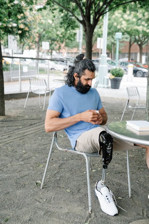 Man with Prosthetic Leg sitting on a Park 