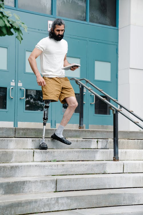 Man with Prosthetic Leg walking Down the stairs