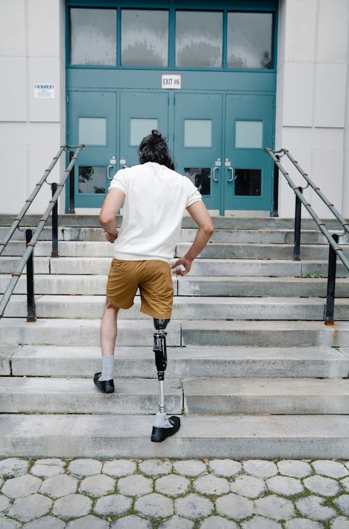 Man with Prosthetic Leg walking up Stairs