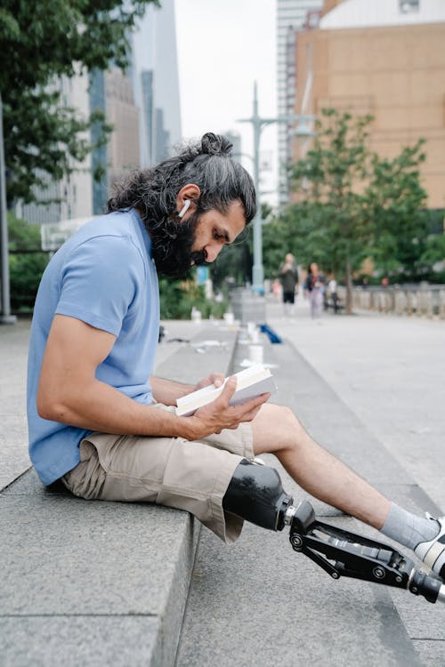 Man with Prosthetic Leg reading a Book 