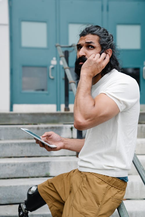 Man leaning on Metal Handrails 