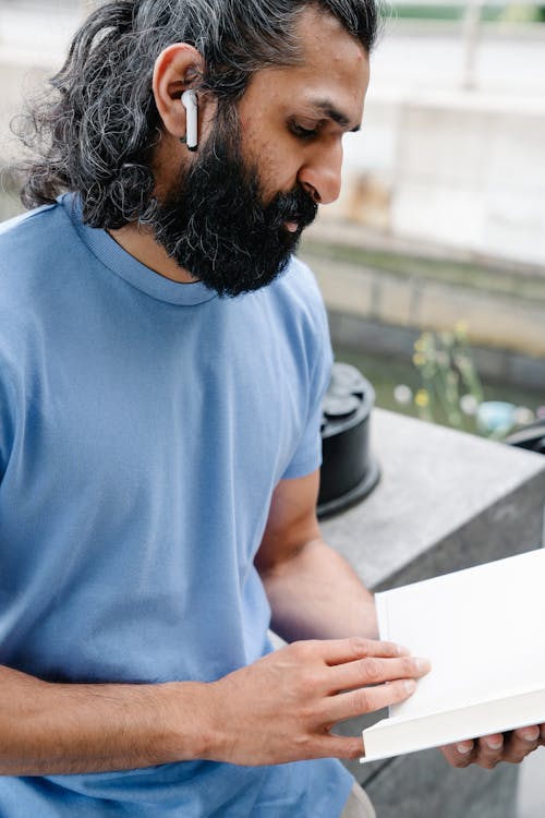 Close-up Photo of Man reading Book 