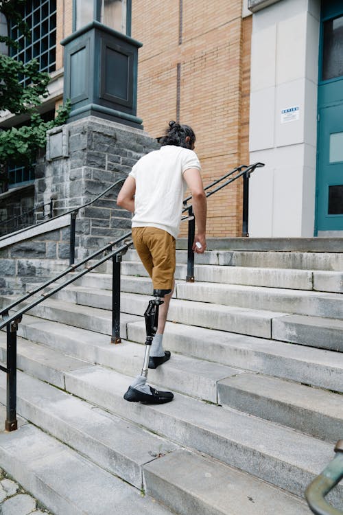 Man with Prosthetic Leg walking up Stairs