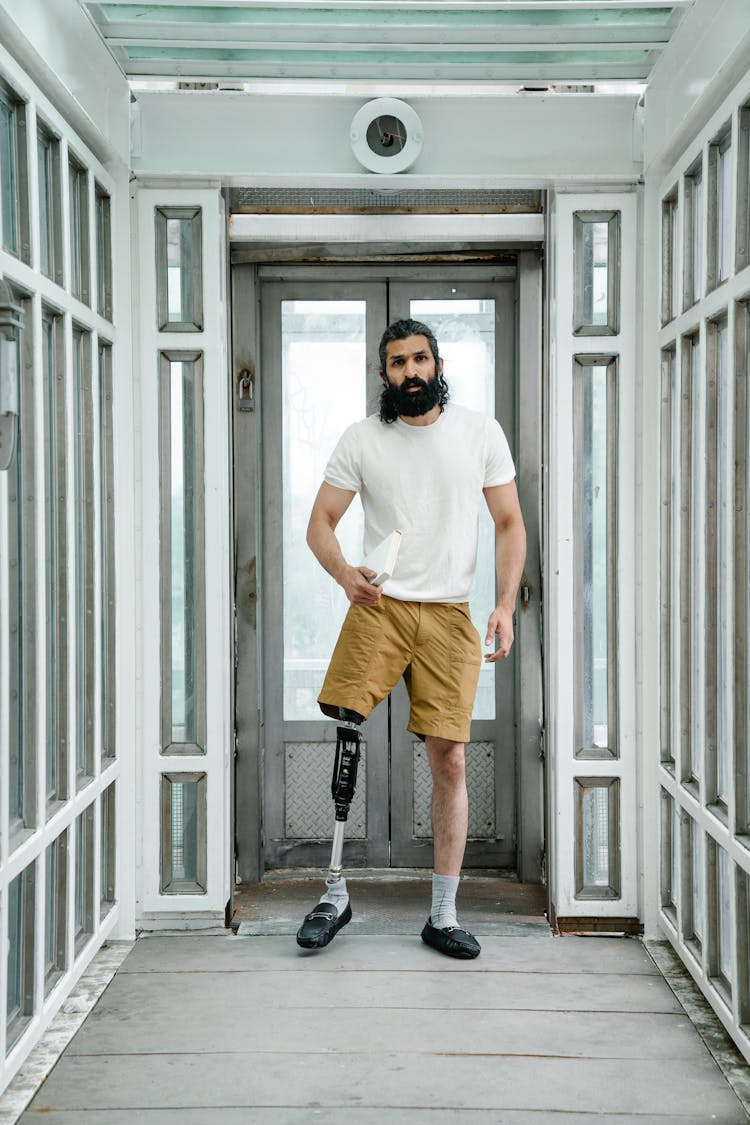 Man With Prosthetic Leg Standing On An Entrance