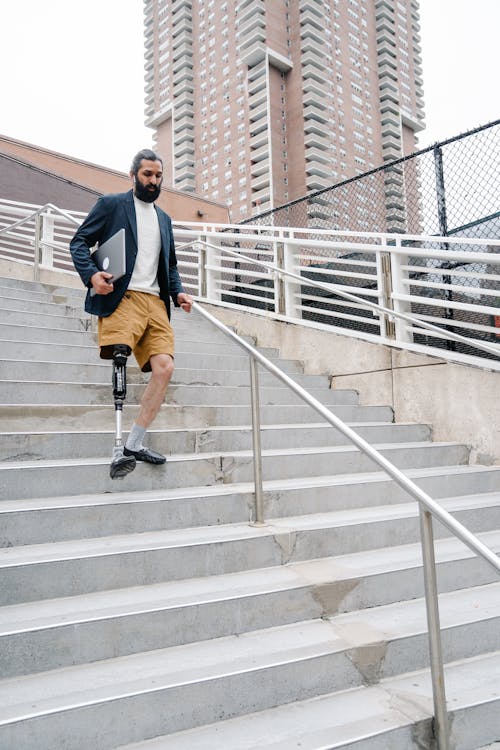 Man with Prosthetic Leg walking Down the stairs