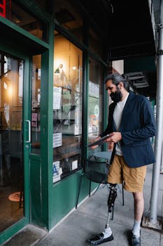 A man with a prosthetic leg entering a cafe, embracing accessibility.