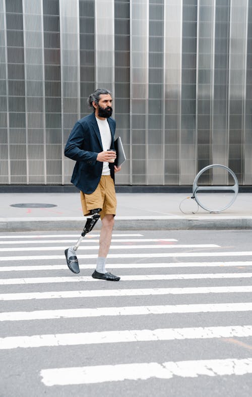 Man with Prosthetic Leg crossing Street