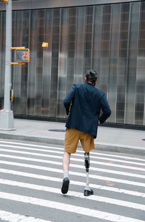 Man with Prosthetic Leg crossing Street
