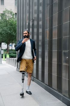 Man with a prosthetic leg walking confidently in an urban setting, showcasing mobility.