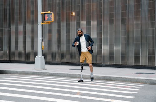 Man with Prosthetic Leg crossing Street