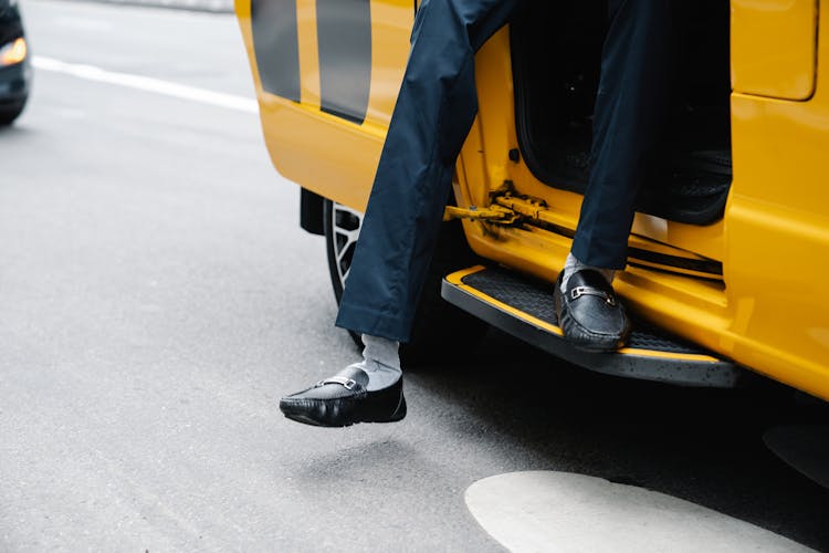 Man Going Out Of The Yellow Vehicle