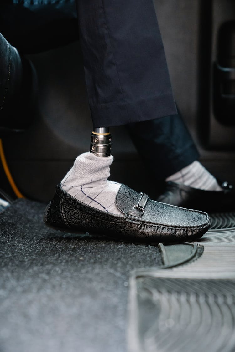 Person With Prosthetic Limb Wearing Black Leather Shoes