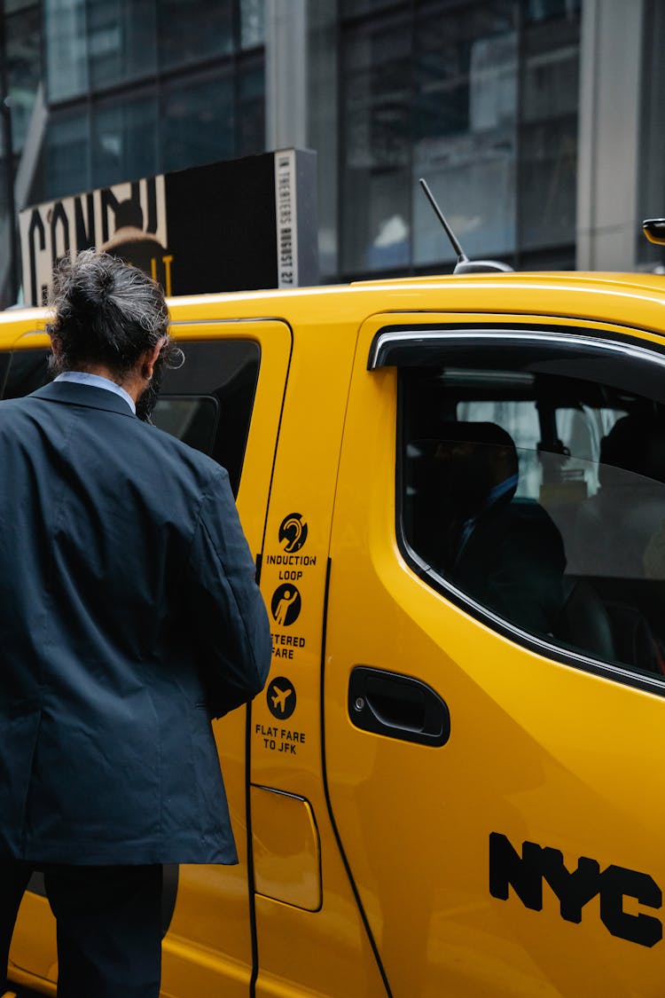 Man Standing In Front Of Taxi 