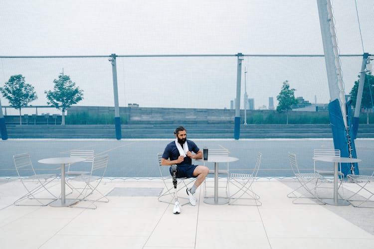 Man With Prosthetic Limb Resting On A Chair