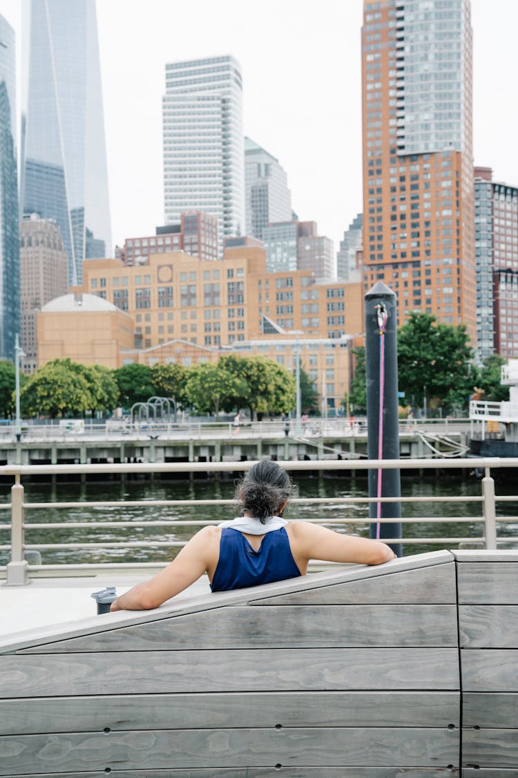 Person Seated On Wooden Bench 