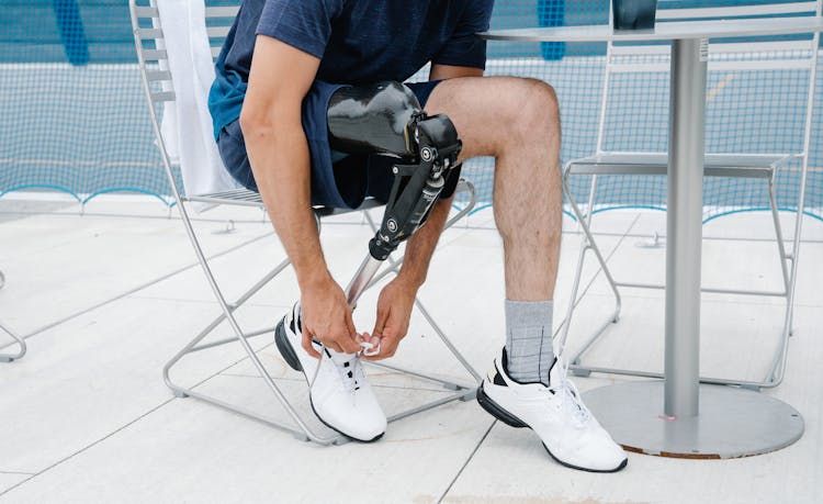 Person With Prosthetic Limb Tying His Shoe Laces