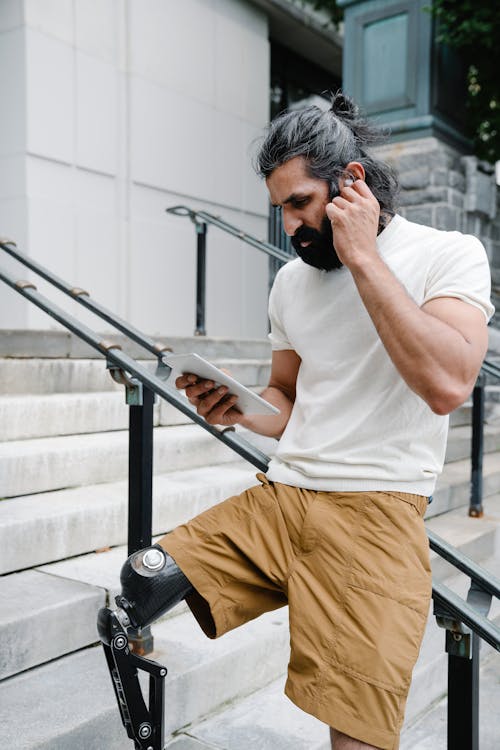 Man leaning on Handrail and reading a Book