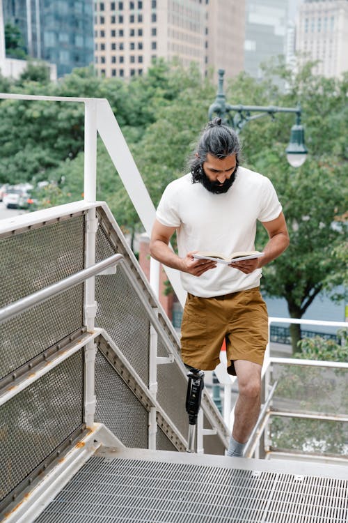 Man walking on Staircase while reading Book 
