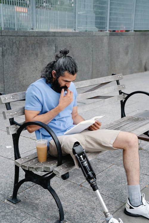 Man with Prosthetic Leg reading a Book 