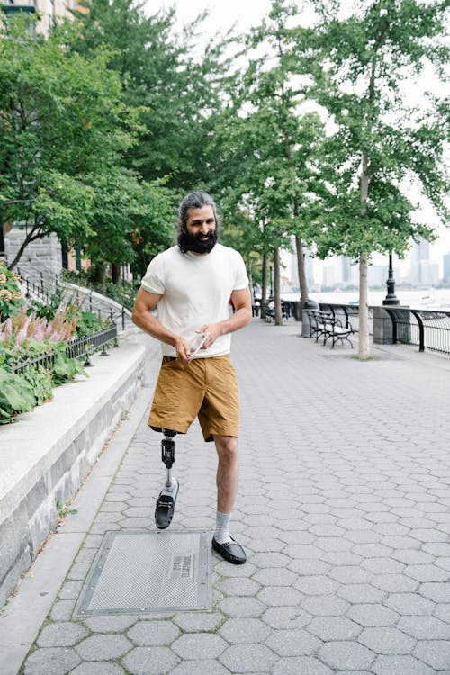 Free Man with Prosthetic Leg walking on Park  Stock Photo