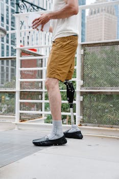 A man with a prosthetic leg strolling outdoors in a city environment, embracing body positivity.