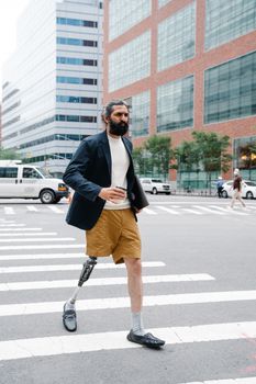 Confident man with prosthetic leg crossing a city street, showcasing empowerment and mobility.