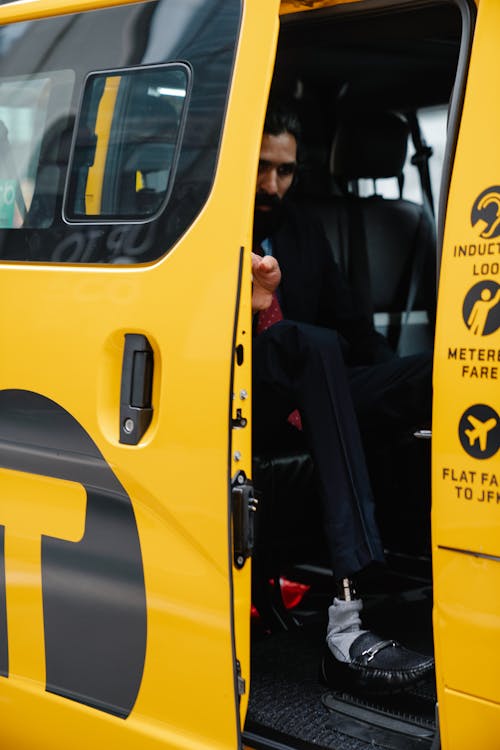 Man with Prosthetic Leg going out a Taxi 