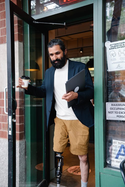 Man exiting a Cafe