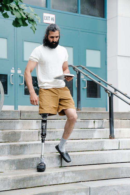 Free Man with Prosthetic Limb walking down the Stairs  Stock Photo