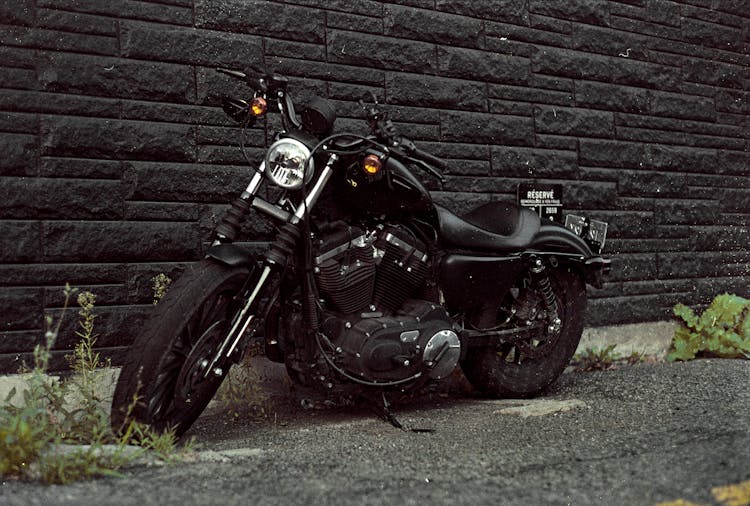 Black Motorcycle Near Building Brick Wall