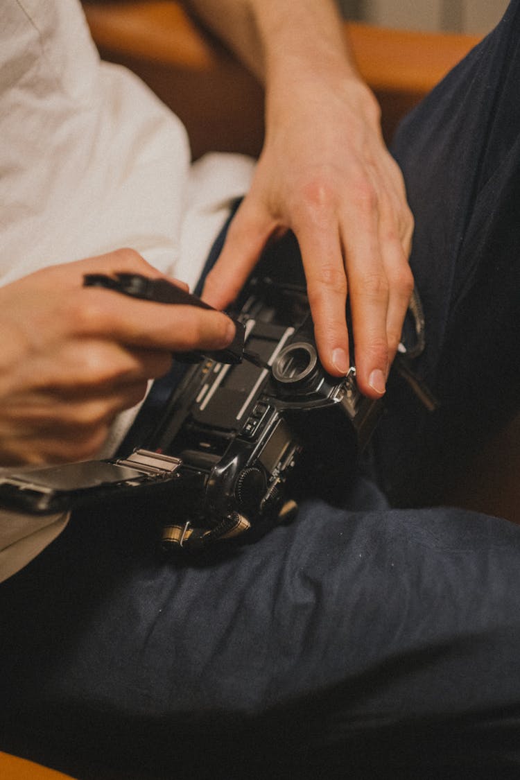 Man Fixing A Camera 