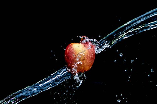 Free Washing a Fresh Apple with Water Stock Photo