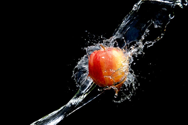 Water Splashing On An Apple