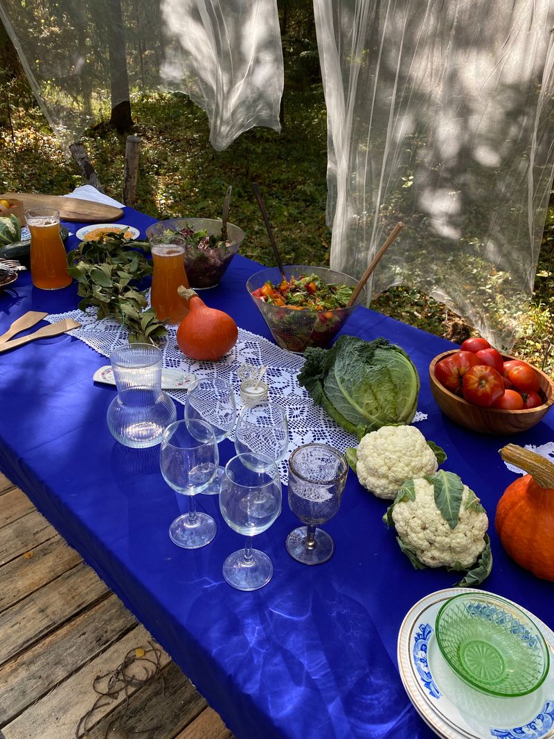 Cozy outdoor autumn gathering with warm lighting and seasonal decorations