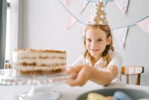 A Girl Holding a Cake